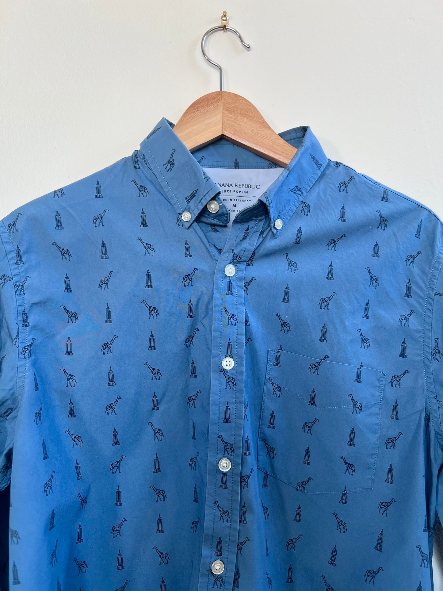 "Banana Republic" blue shirt with giraffe and building - Size M